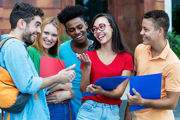 Group of adolescent students engaged in conversation
